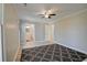 The primary bedroom features hard wood floors, a ceiling fan, and a view into the ensuite bathroom at 9450 Old Palmetto Rd., Murrells Inlet, SC 29576