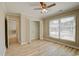 Bright bedroom features a ceiling fan, light wood floors and a closet with white folding doors at 9450 Old Palmetto Rd., Murrells Inlet, SC 29576