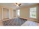 Cozy bedroom features wood flooring, a ceiling fan, closet with white folding doors, and natural light at 9450 Old Palmetto Rd., Murrells Inlet, SC 29576