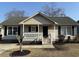 Charming single-story home with a welcoming front porch, black shutters, and landscaped front yard at 9450 Old Palmetto Rd., Murrells Inlet, SC 29576