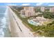 Stunning aerial view of a luxury resort situated on the beach, complete with pools and oceanfront access at 9684 Ravello Ct., Myrtle Beach, SC 29577