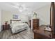 Comfortable bedroom with a ceiling fan, dresser, and queen bed with decorative pillows and a matching floral quilt at 1031 Madge Ct., Conway, SC 29526