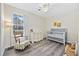 Brightly-lit Bedroom with a crib, rocker, dresser and plush animals at 1031 Madge Ct., Conway, SC 29526