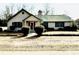 Charming brick home with a green metal roof, well-maintained landscaping, and a welcoming entrance at 11 S Beech Ave., Andrews, SC 29510