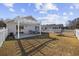 Nice backyard with a pergola-covered patio, fenced yard, and landscaping at 1130 Ganton Way, Myrtle Beach, SC 29588