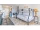 Bedroom with a bunk bed, full bed, a black futon, and tile floors at 1207 S Ocean Blvd. # 51305, Myrtle Beach, SC 29577