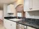 Kitchen features white cabinetry, stainless steel appliances, and a view to the living space at 126 Fox Haven Blvd., Myrtle Beach, SC 29588