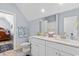 Bathroom with a double sink, marble countertop, and wood-look tile floors at 129 Marblehead Dr., Little River, SC 29566