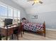 Bedroom with gray walls, wood-look flooring and natural light at 129 Marblehead Dr., Little River, SC 29566