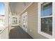 Exterior shot featuring a covered porch, white columns, and a view of neighboring homes at 129 Marblehead Dr., Little River, SC 29566