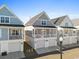 Charming coastal home with double garage, second-story deck, and inviting curb appeal at 129 Marblehead Dr., Little River, SC 29566