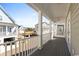 Covered porch with railing offering views of the community and neighboring houses at 129 Marblehead Dr., Little River, SC 29566