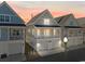 Inviting two-story beach home with a covered porch and ground-level garage at sunset at 129 Marblehead Dr., Little River, SC 29566