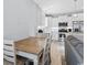 Modern kitchen with white cabinets, stainless steel appliances, an island with seating, and a dining table at 129 Marblehead Dr., Little River, SC 29566