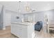 Bright and airy kitchen with a marble island, seating, white cabinets, and hardwood flooring at 129 Marblehead Dr., Little River, SC 29566