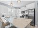 Bright kitchen featuring stainless steel appliances, island with seating, and white subway tile backsplash at 129 Marblehead Dr., Little River, SC 29566