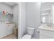 Functional laundry and half-bath combination, featuring modern appliances and ample storage at 129 Marblehead Dr., Little River, SC 29566