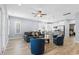 Open-concept living area featuring hardwood floors, ceiling fan, and kitchen with stainless steel appliances at 129 Marblehead Dr., Little River, SC 29566