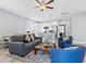 Bright living room with hardwood floors, stylish furniture, ceiling fan, and an open kitchen concept at 129 Marblehead Dr., Little River, SC 29566