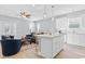 Open-concept living room with kitchen island, stainless appliances, and hardwood floors at 129 Marblehead Dr., Little River, SC 29566