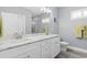 Spa-like bathroom featuring double sinks, marble countertops, white cabinetry, and a walk-in shower at 129 Marblehead Dr., Little River, SC 29566