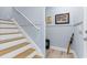 Stairway with wood treads, white risers, blue walls, and white trim and a door to the garage at 129 Marblehead Dr., Little River, SC 29566