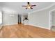 Living room with hardwood floors leading to a kitchen with breakfast bar at 133 Puffin Dr. # 1-E, Pawleys Island, SC 29585