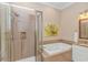 Bathroom featuring soaking tub, glass enclosed shower, and beautiful tiled walls at 14300 Ocean Hwy. # 205, Pawleys Island, SC 29585