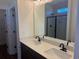 Bathroom featuring double sinks with dark cabinetry and black fixtures at 148 Joyce Dr, Longs, SC 29568