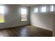 Bedroom bathed in natural light from multiple windows and featuring wood-look flooring at 148 Joyce Dr, Longs, SC 29568