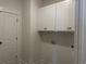 Functional laundry room with crisp white cabinetry and essential utility connections at 148 Joyce Dr, Longs, SC 29568