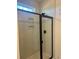 Modern tiled shower with a sleek black frame and built in storage shelves at 148 Joyce Dr, Longs, SC 29568