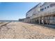Beautiful beach and pier with buildings on stilts, perfect for a day of relaxation at 1510 S Ocean Blvd. # 101, Surfside Beach, SC 29575