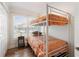 Bedroom featuring a bunk bed, wood floors, natural light, and a closet for storage at 1510 S Ocean Blvd. # 101, Surfside Beach, SC 29575