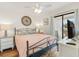 Bedroom features a bed, tv, access to a balcony and ceiling fan providing a comfortable space to relax at 1510 S Ocean Blvd. # 101, Surfside Beach, SC 29575