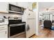 Well-equipped kitchen with stainless steel oven, microwave, and a view into the living area at 1510 S Ocean Blvd. # 101, Surfside Beach, SC 29575
