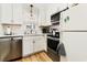 Modern kitchen featuring stainless steel appliances, white cabinetry, and stylish backsplash at 1510 S Ocean Blvd. # 101, Surfside Beach, SC 29575