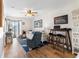 Comfortable living room featuring a ceiling fan, sofa, accent chair, and beach-themed decor at 1510 S Ocean Blvd. # 101, Surfside Beach, SC 29575