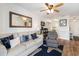 Comfortable living room featuring coastal accents, wood floors, and a view into the kitchen area at 1510 S Ocean Blvd. # 101, Surfside Beach, SC 29575