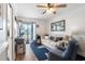 Cozy living room with a ceiling fan, sofa, accent chair, and balcony access featuring coastal-themed decor at 1510 S Ocean Blvd. # 101, Surfside Beach, SC 29575