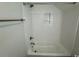 A tiled shower and tub with a built-in niche provide a clean and modern bathroom at 172 Enclave Pl., Pawleys Island, SC 29585