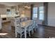 Open kitchen and dining area with white cabinets, island, and large windows at 172 Enclave Pl., Pawleys Island, SC 29585