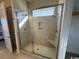 Modern bathroom shower with tiled walls, glass door and built in shower seat at 172 Enclave Pl., Pawleys Island, SC 29585