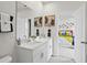 Bright bathroom with double sinks, modern fixtures, and a view into an adjacent bedroom at 2027 Copper Creek Loop, Longs, SC 29568