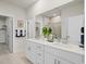 Bright bathroom with double vanity, white cabinets, and a glass-enclosed shower at 2027 Copper Creek Loop, Longs, SC 29568