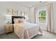 Tranquil bedroom featuring soft lighting, a comfortable bed, and a large window with pleasant outdoor views at 2027 Copper Creek Loop, Longs, SC 29568