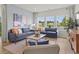 Comfortable living room with large windows showcasing scenic pond views and stylish furnishings at 2027 Copper Creek Loop, Longs, SC 29568