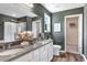 A modern bathroom features double sinks with granite countertops and a walk-in shower at 203 Wagner Cir., Conway, SC 29526