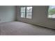 Bright bedroom features neutral carpet, three windows offering natural light, and freshly painted walls at 203 Wagner Cir., Conway, SC 29526