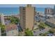 An aerial view showing a multi-story condo with a pool, parking lot, and nearby beach at 210 75Th Ave N # 4032, Myrtle Beach, SC 29572